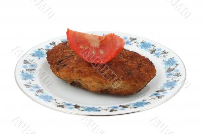 steak with tomato on a patterned plate