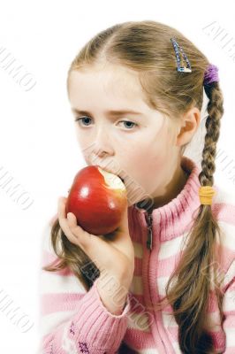 A thoughtfull girl eating an apple