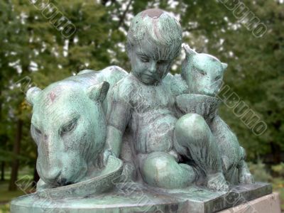In the zoo. Statue of the child In the zoo. Statue of the child
