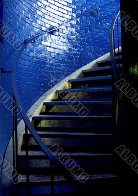 Spiral staircase and stark blue walls