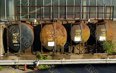 A row of four oil storage tanks