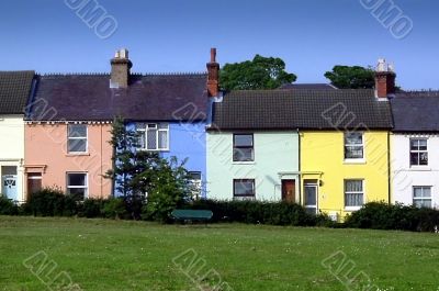 row of village houses painted in pastel colours