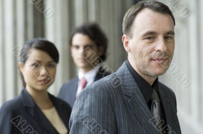 Smiling Businessman With Team