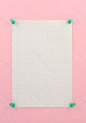 piece of squared paper pinned to pink wall