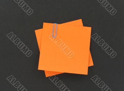 two paper notes with a paperclip