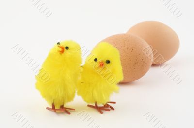 two easter toy chickens with eggs