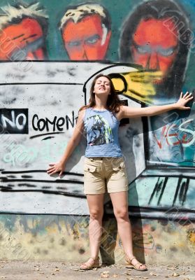 woman in front of grafitti covered wall woman in front of grafitti covered wall