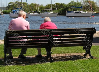 two friends relaxing at waters edge