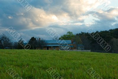 Green fields at Sunset under a Cloudy Sky Green fields at Sunset under a Cloudy Sky
