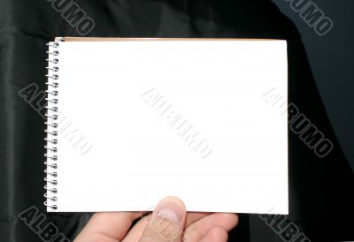 holding blank spiral notebook