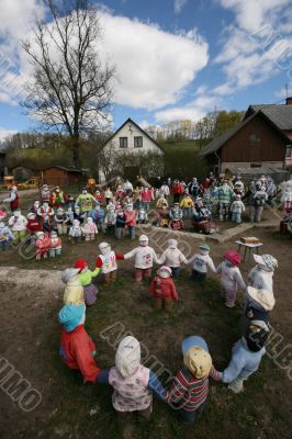 Rag dolls in village house yard under clouds