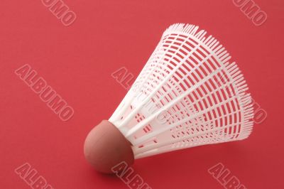 Shuttlecock on red