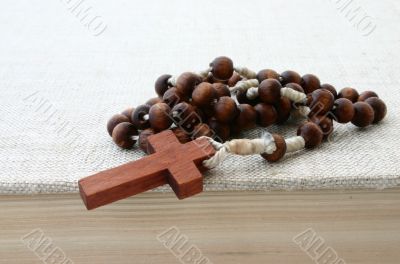wooden rosary on bible