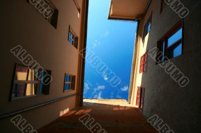 House wall with windows, reflections, shadows