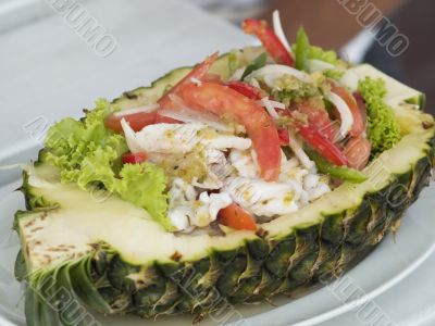 Seafood salad in a pineapple