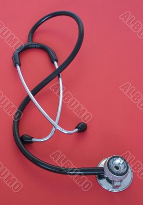 stethoscope on red background
