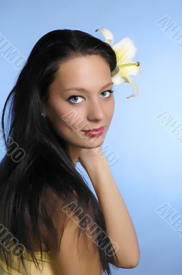 The beautiful girl with a lily in hair