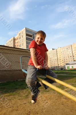 smiling boy on a swing