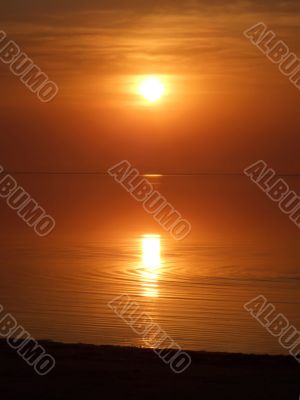 Orange sunset above a quiet serene gulf