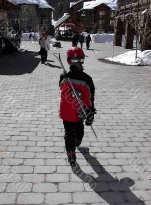 girl walking through ski village