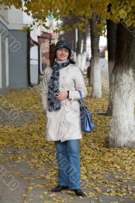 woman in autumn city street.