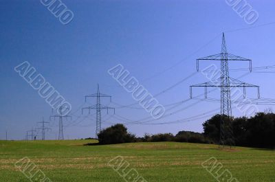 blue sky on grass and transmission facilities