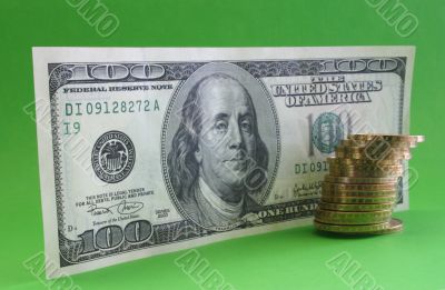 One hundred dollar note with coins One hundred dollar note with coins