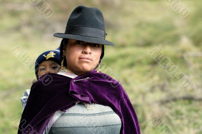 latin woman in national clothes with little child