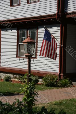 American flag and classic New England House