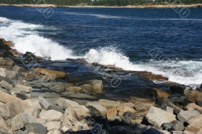 Breaking waves on granite ledges