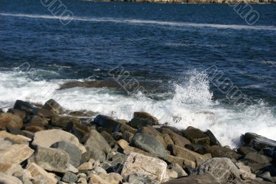 Breaking waves on granite ledges