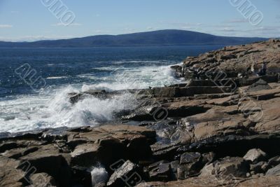 Breaking waves on granite ledges