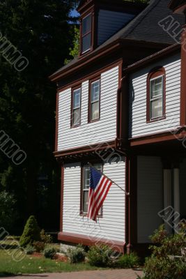 American flag and classic New England House