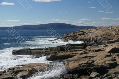 Breaking waves on granite ledges