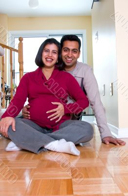 Happy expectant couple at home Happy expectant couple at home