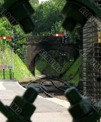 Railway tunnel framed by nuts and bolts