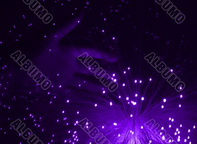 hand and purple fibre optic