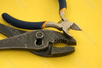 close-up of pliers on yellow