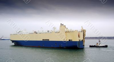 cargo ship and tug