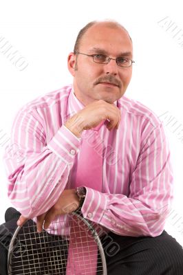 Handsome businessman leaning on squashracket