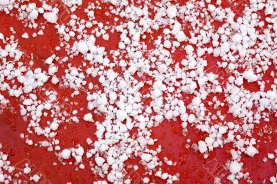 Snow on a cowl of the red car