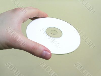 hand holding a blank cd