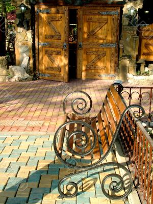 Garden bench before the entrance in the cafe