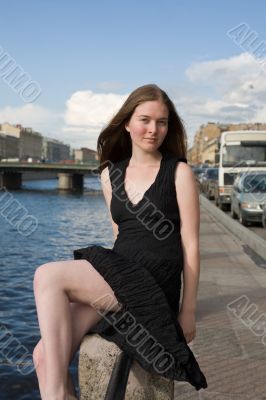 girl on a fencing of quay