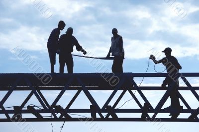 silhouette workers on construction site