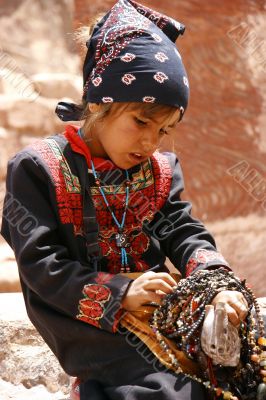 young asian girl selling beads