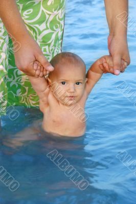 father teaching his son to swim