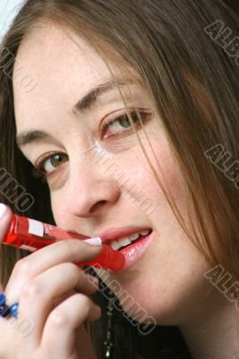 applying red lipstick
