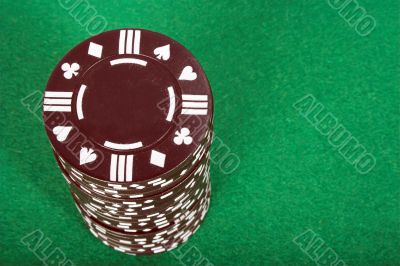 brown pile of casino chips over green