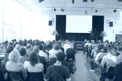 business man giving a conference - cyan